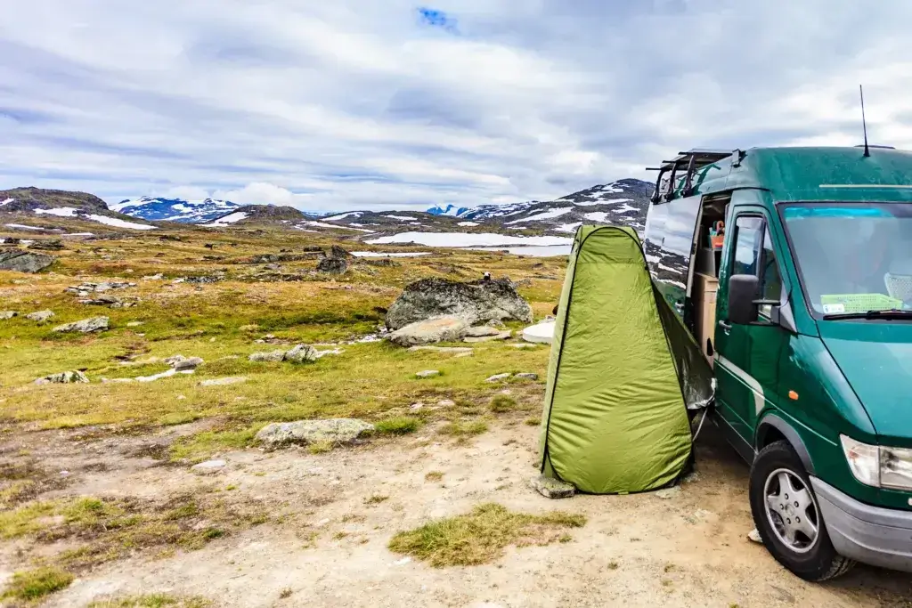 Camper car and portable shower bath tent on norwegian nature - how to take a hot shower while camping.