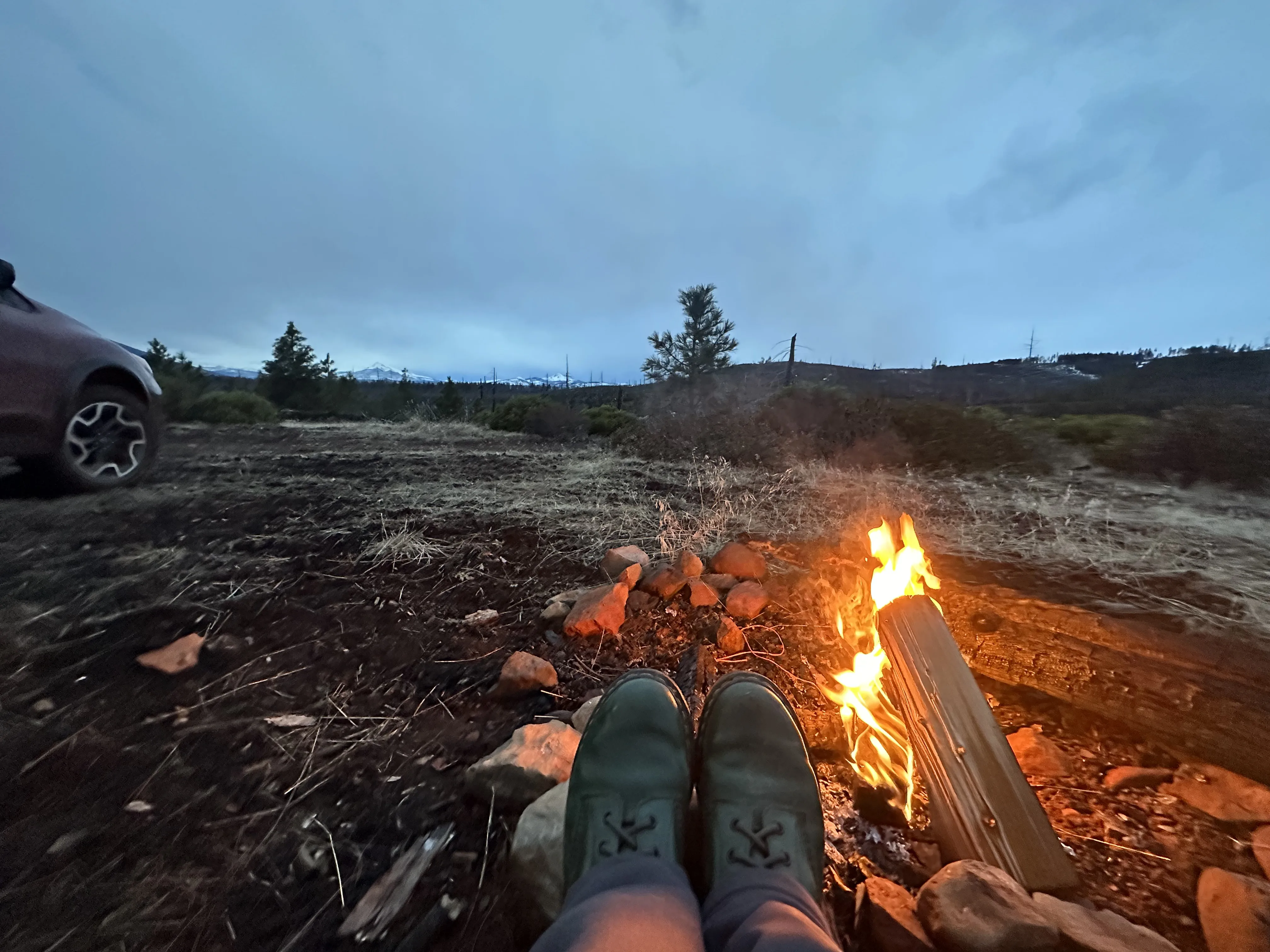 Campfire with mountains in the background.