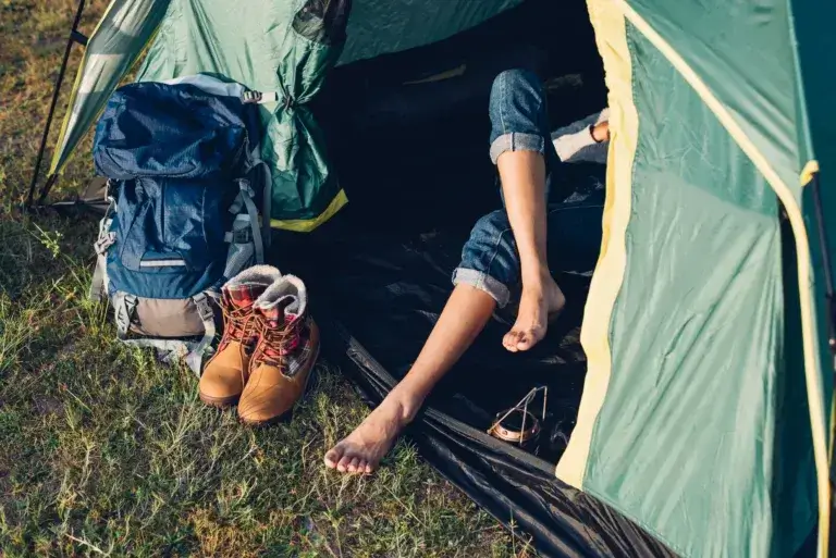 Young Woman camping in forest on summer