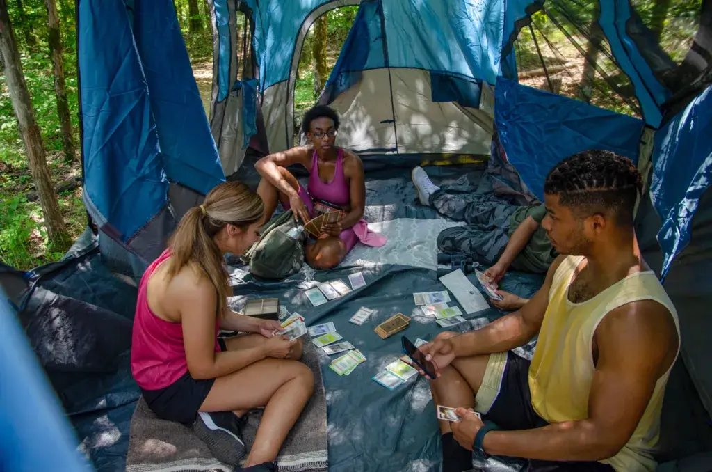 Friends in a tent playing camping games.