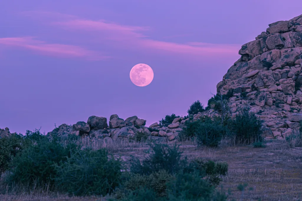 Scenic hike at dusk with a full moon in the background.
