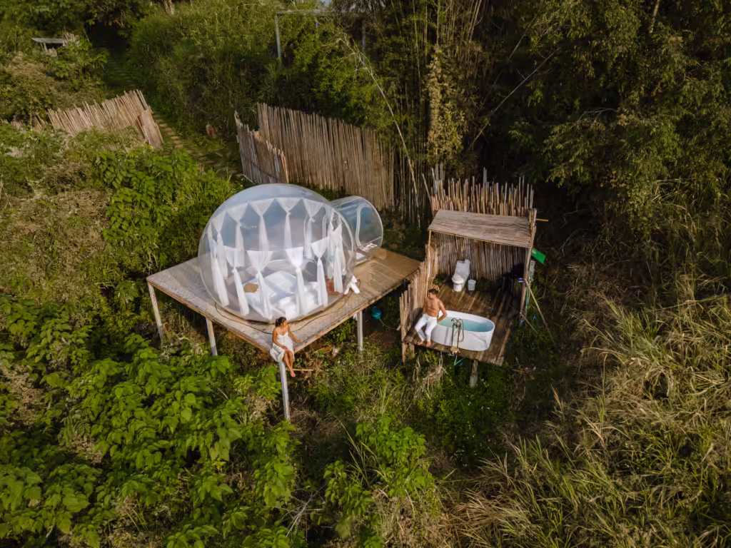 Bubble dome tent glamping in the mountains of Chiang Mai Thailand,Transparent bell tent with comfortable bed and pillow in forest, glamping hotel, luxury travel, glamourous camping