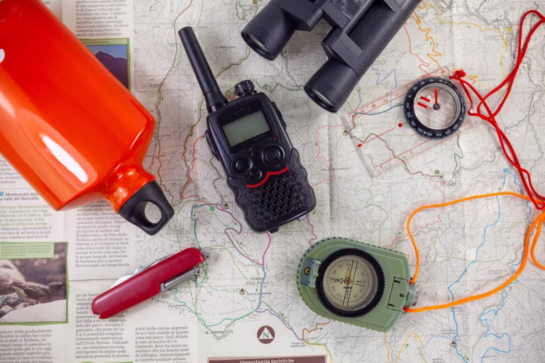 tools for camping and outdoor life cards compasses water bottles binoculars and knife italy