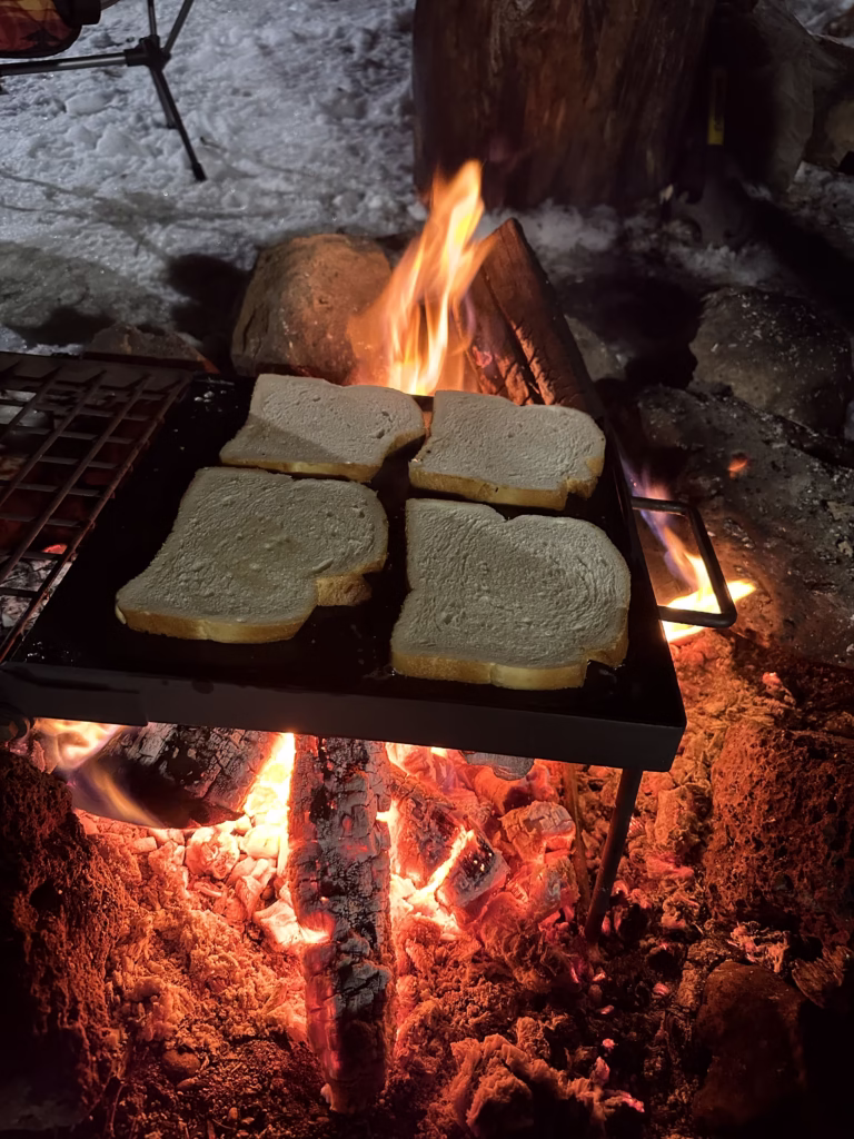 Grill with bread over a campfire to make campfire toast.