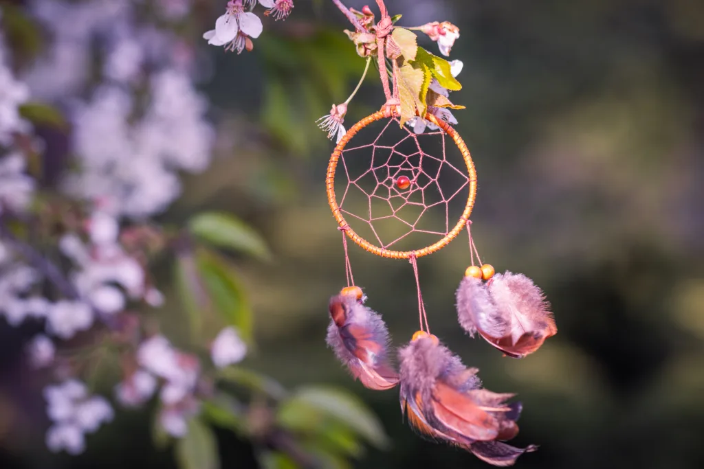 Dreamcatcher outside with spring time flowers.