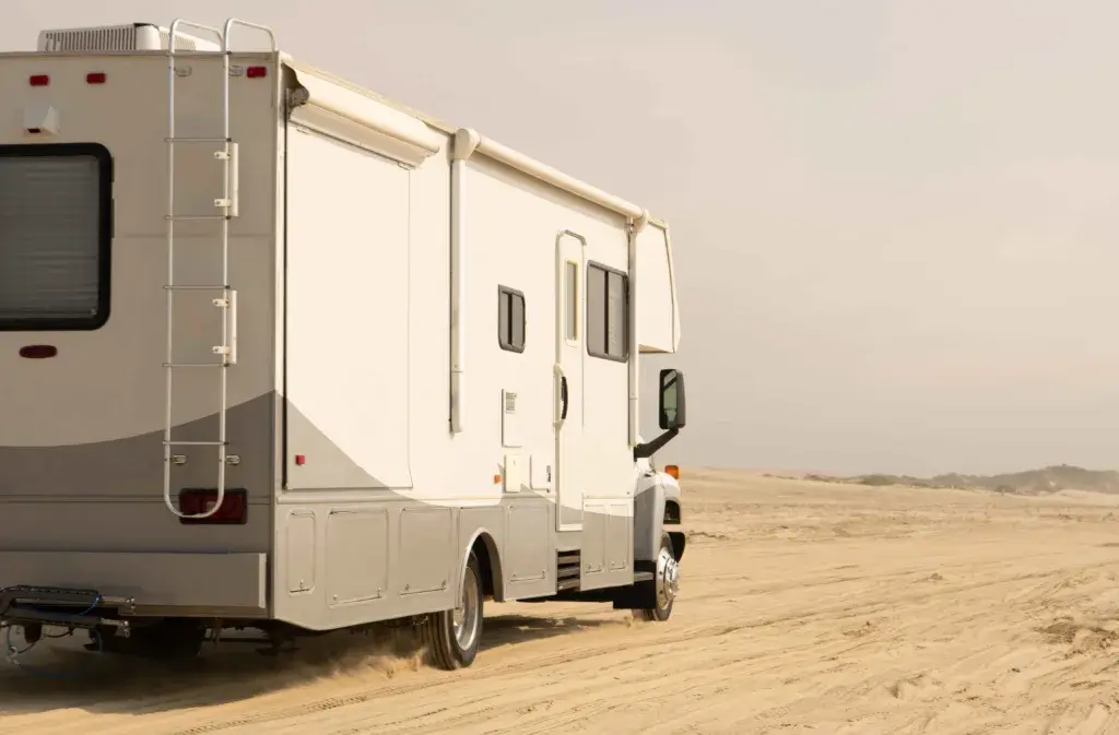 Motorhome driving on the sand.