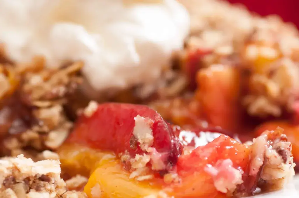 Peach cobbler with a crumble topping.