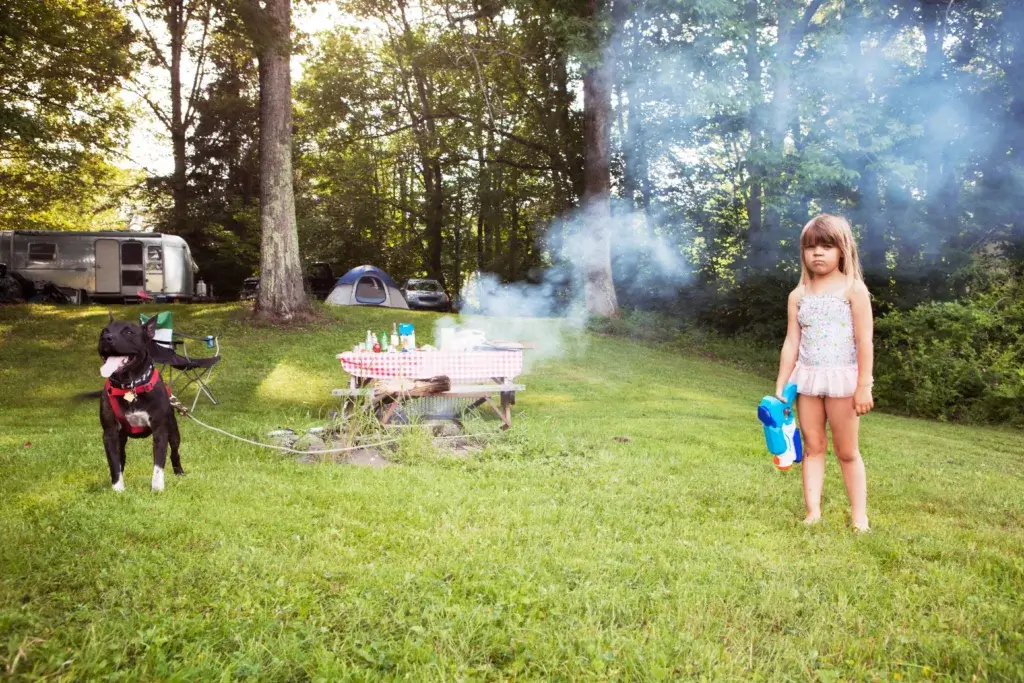 Young girl and dog at a campground.