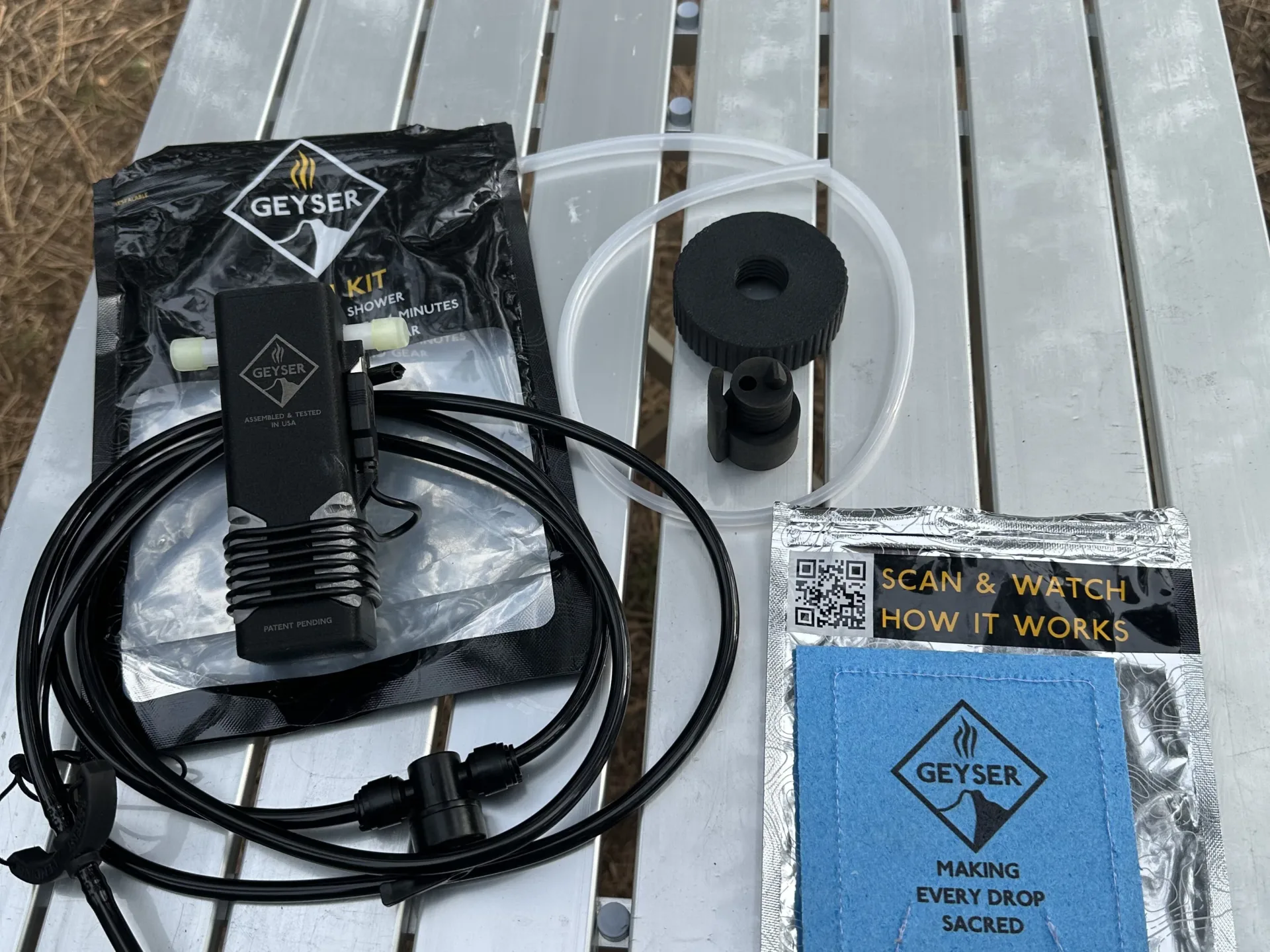 Geyser Clean Kit components sitting on a silver camp table.