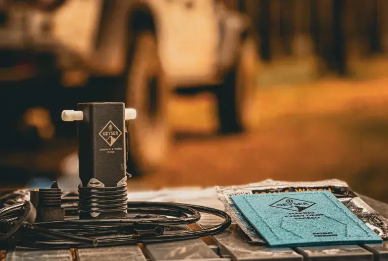 Geyser Clean Kit sitting on a table with a Jeep Gladiator in the background.