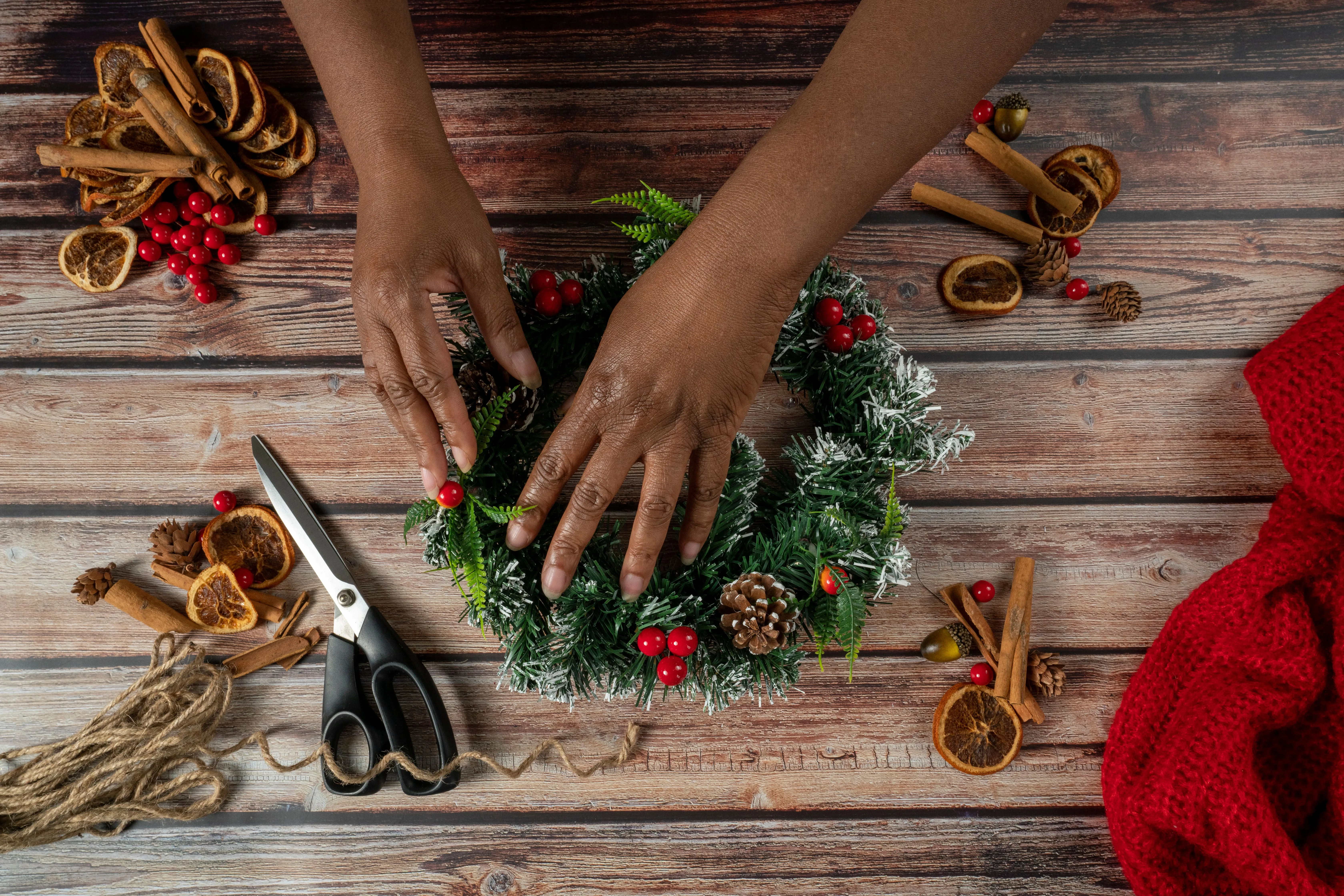 Making a wreath out of natural materials like pinecones and pine trees.