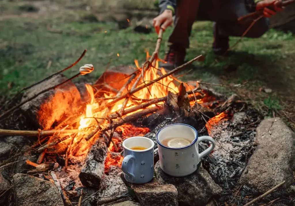 Making hot drinks over a campfire.