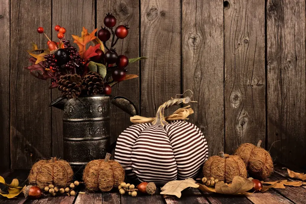 Fall decorations, including a pumpkin made out of twine and striped fabric.
