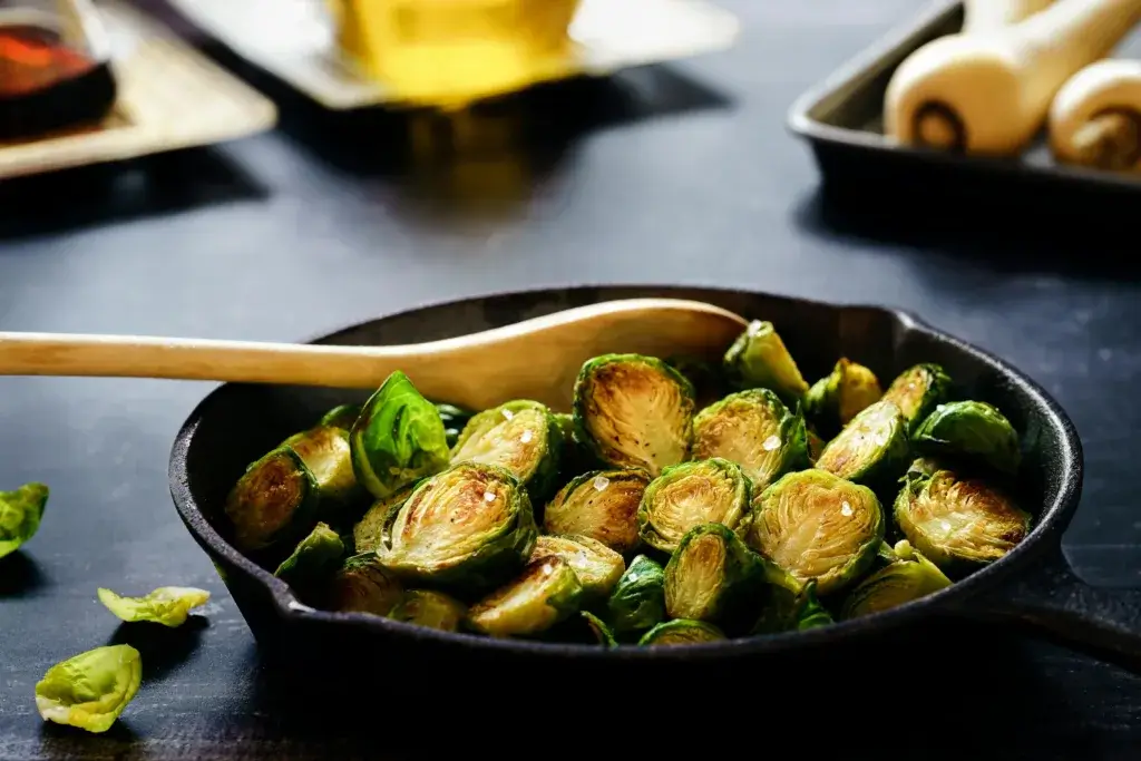 Close-up of delicious roasted Brussels sprouts in a cast iron skillet, perfect for a healthy meal.