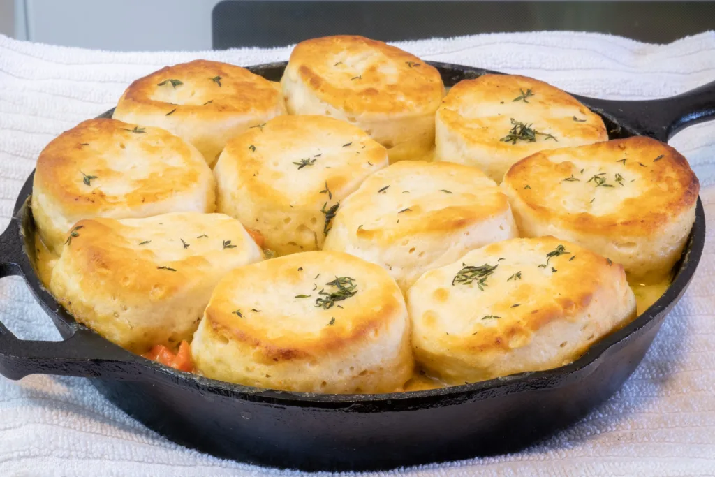 A steaming chicken pot pie in cast iron skillet.