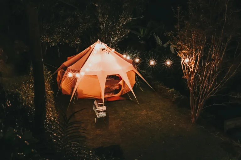Illuminated tent setup for a cozy camping night in a São Paulo garden.