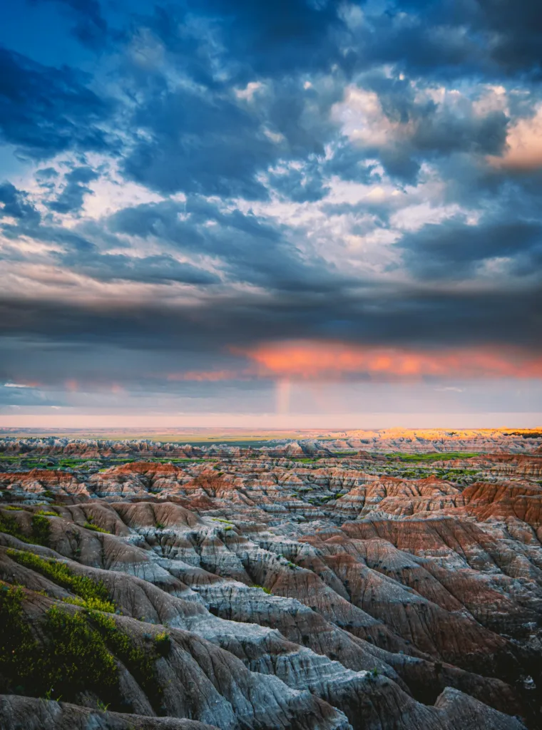 Breathtaking view of Badlands' eroded formations at twilight, showcasing vibrant colors and dramatic skies.