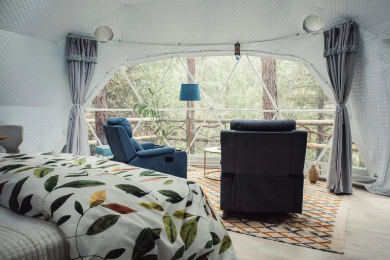 Stylish interior of a glamping dome with forest view in Cuenca, Ecuador.