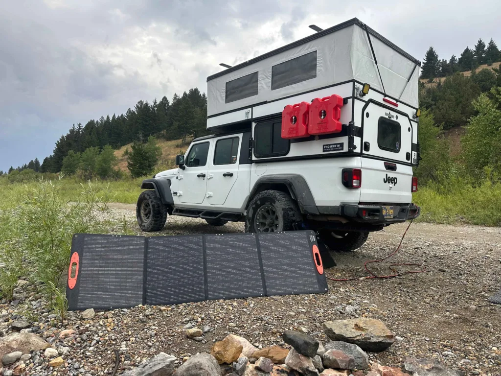 Jeep gladiator with a Project M camper and a solar panel.
