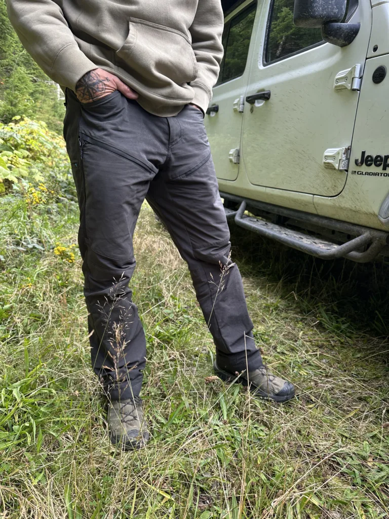 Man standing next to a Jeep wearing KUHL RADIKL Outsider pants.