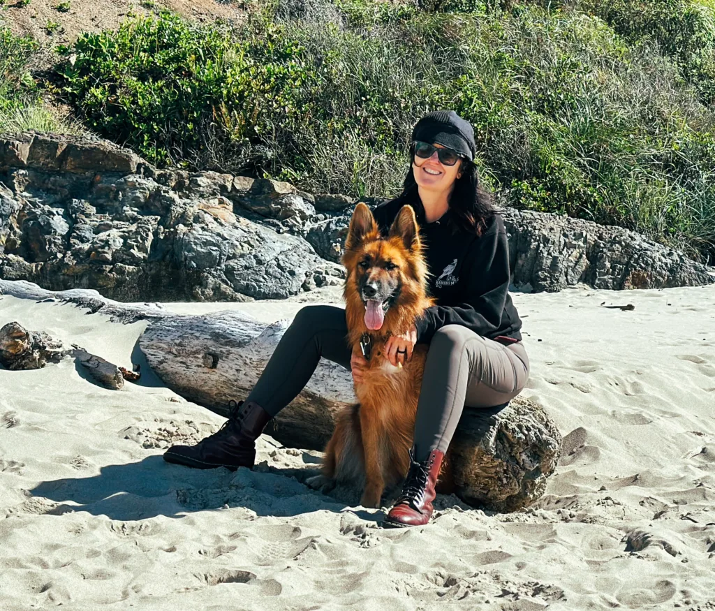 Woman and German Shepherd dog wearing KUHL Frost Softshell Tights.