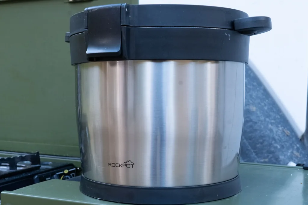 Rockpot is sitting on a camp kitchen.