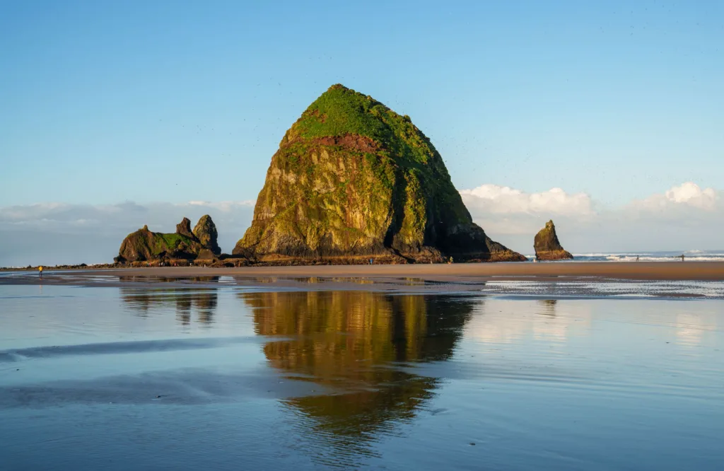 Beautiful view of Haystack Rock reflecting on the water at Cannon Beach, Oregon.